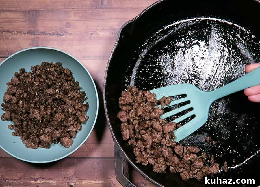 Creamy Ground Beef Stroganoff Recipe with Greek Yogurt 6 reserving the cooked ground beef into a bowl.