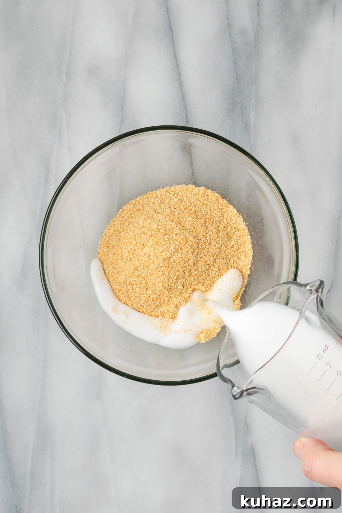 Gluten free bread crumbs and milk combined in a small mixing bowl. 