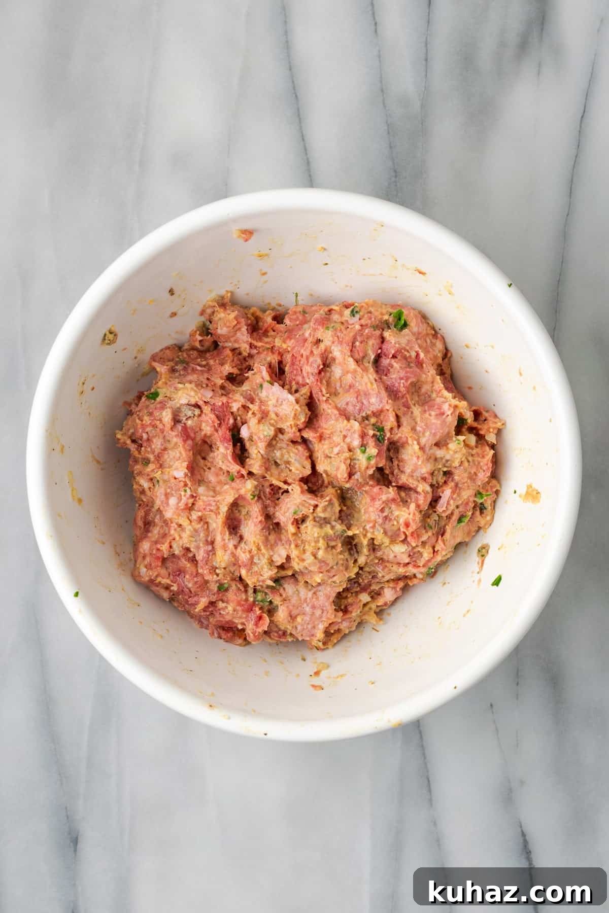 Gluten free meatball mixture combined in a large bowl.