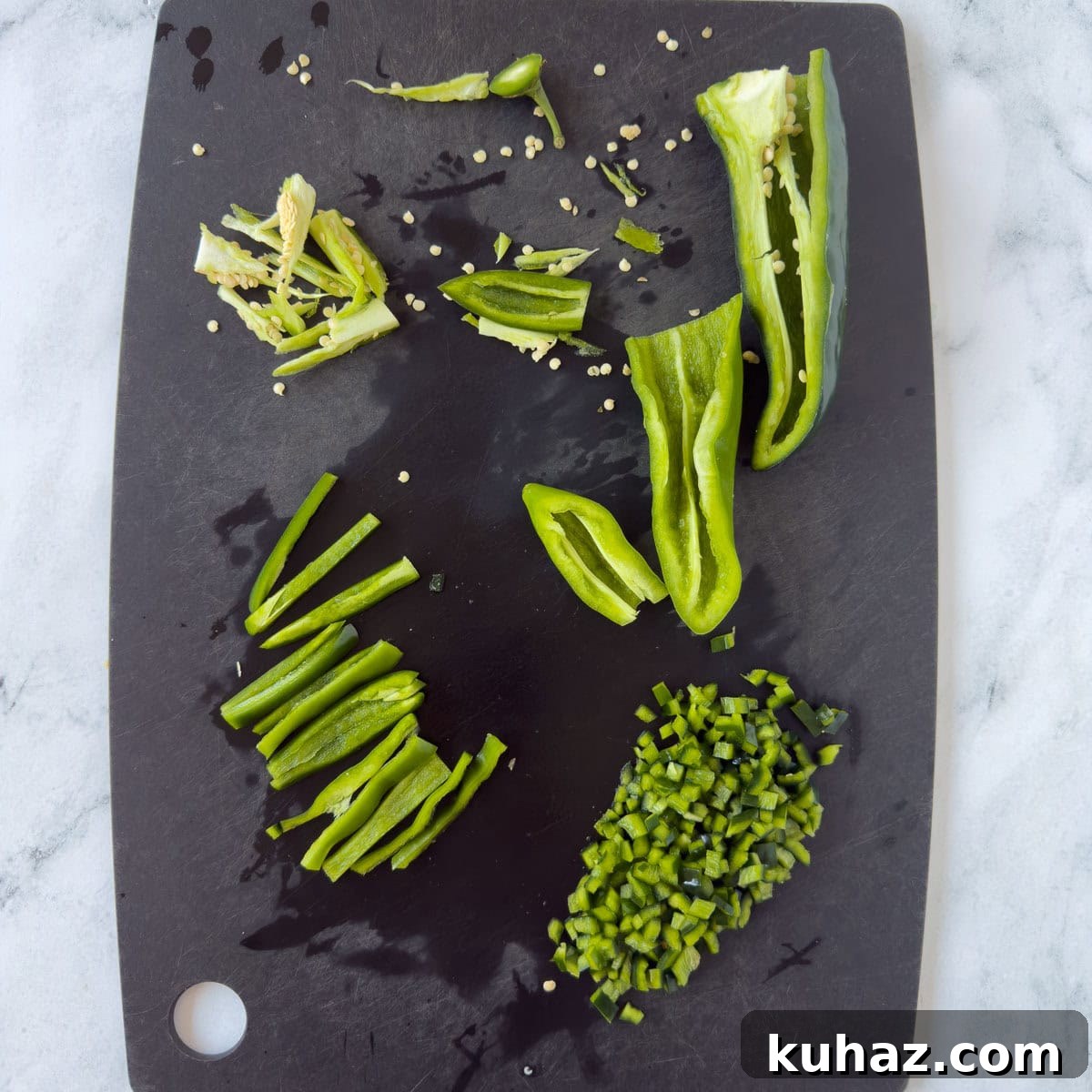 Zesty Tomatillo Soup Recipe with Chicken or Turkey 4 Chopping fresh green chili peppers on a black cutting board.