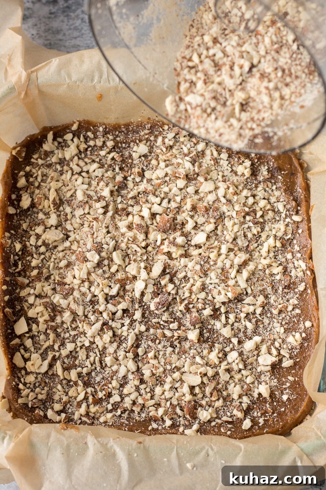 Date, Caramel and Nougat Bars Recipe 6 crushed almonds sprinkled on top of date caramel and nougat
