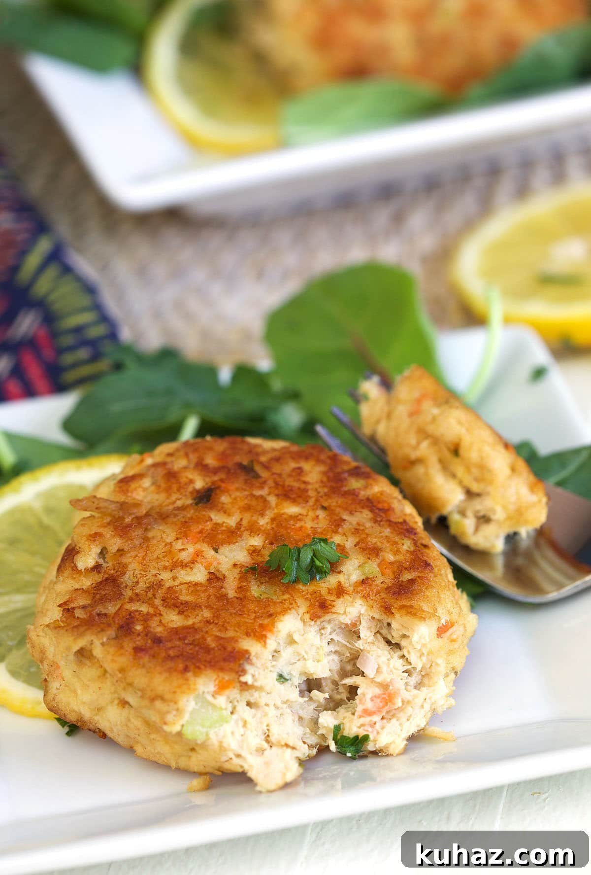 A bite of tuna patty has been removed with a fork.