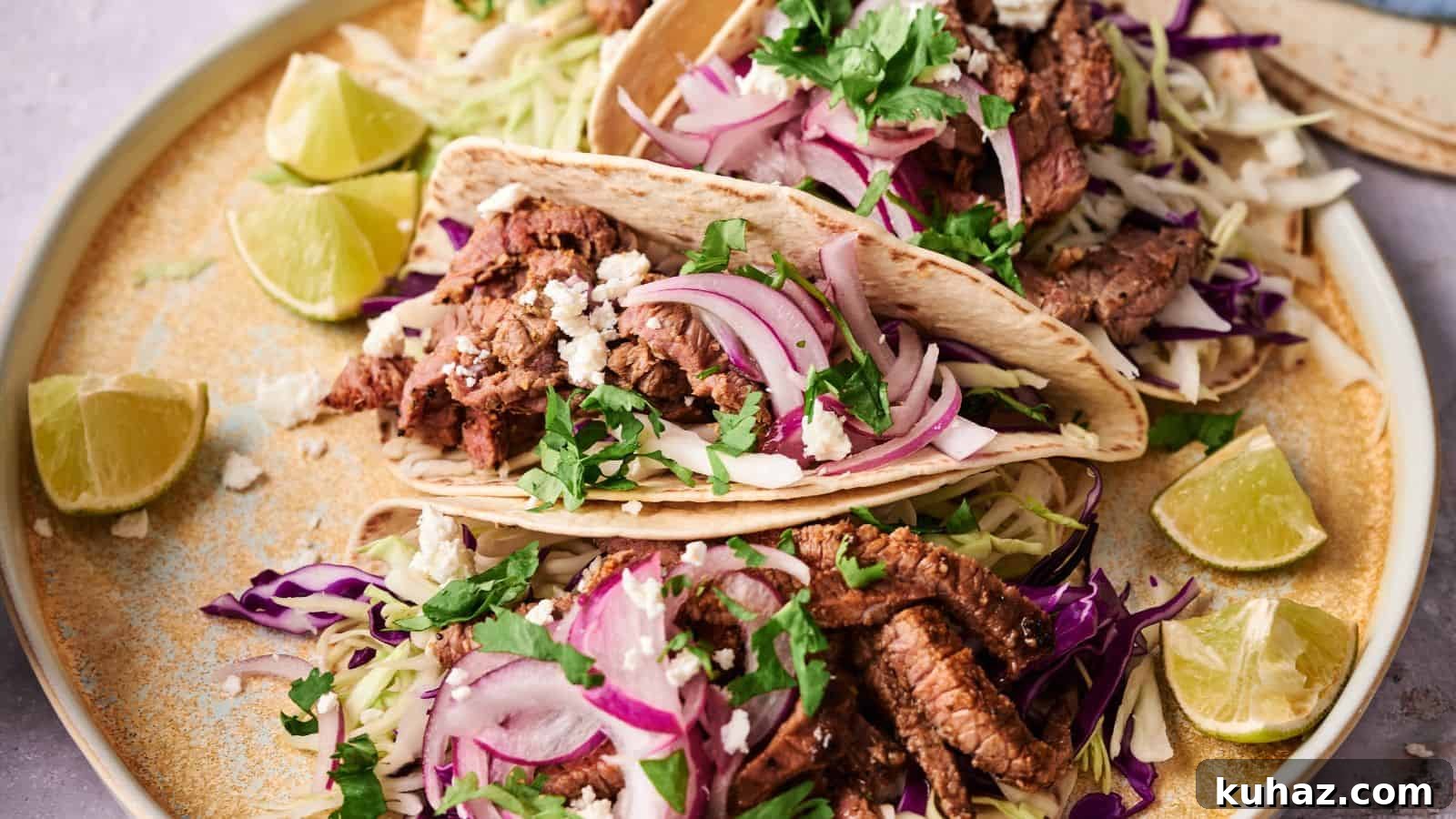 19 BBQ Dinner Recipes That Made Dad Stop Asking What's Next 16 Two beef tacos on a plate, topped with sliced red onions, shredded cabbage, cilantro, and crumbled cheese, surrounded by lime wedges.