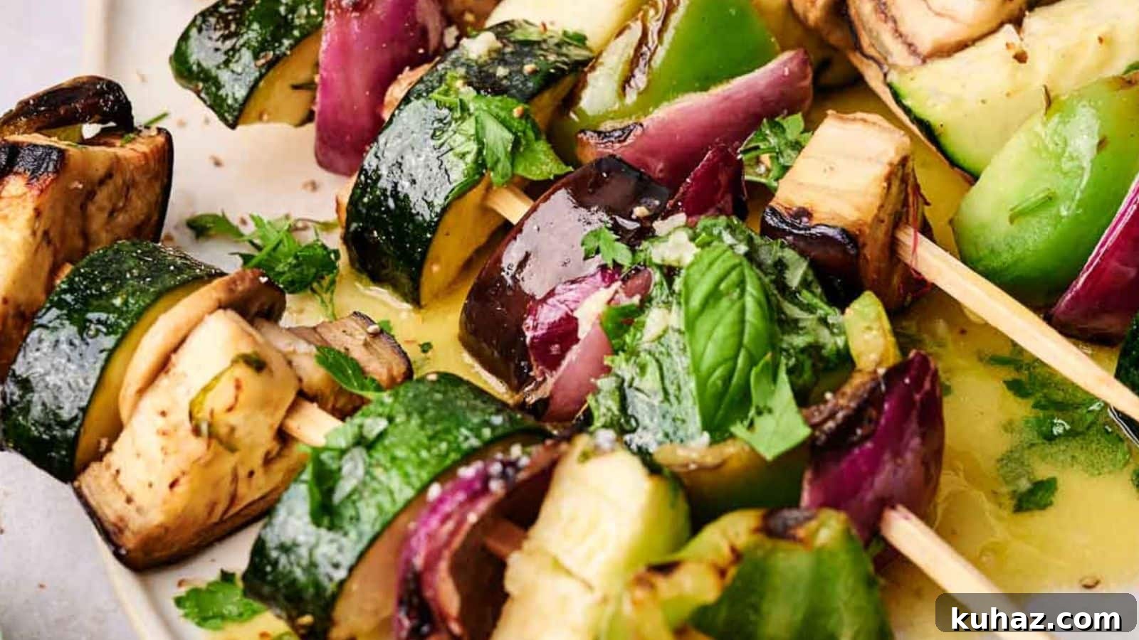 19 BBQ Dinner Recipes That Made Dad Stop Asking What's Next 20 Close-up of grilled veggie kabobs with zucchini, bell peppers, eggplant, and onions, garnished with fresh herbs.