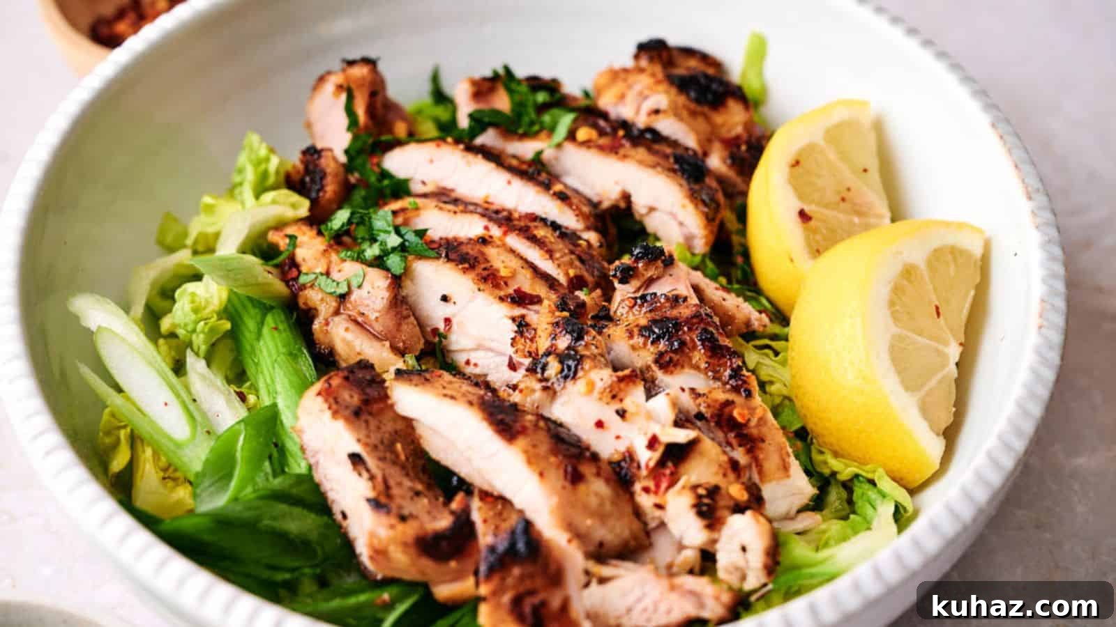 19 BBQ Dinner Recipes That Made Dad Stop Asking What's Next 6 Grilled chicken breast slices served over a bed of greens with lemon wedges on the side.