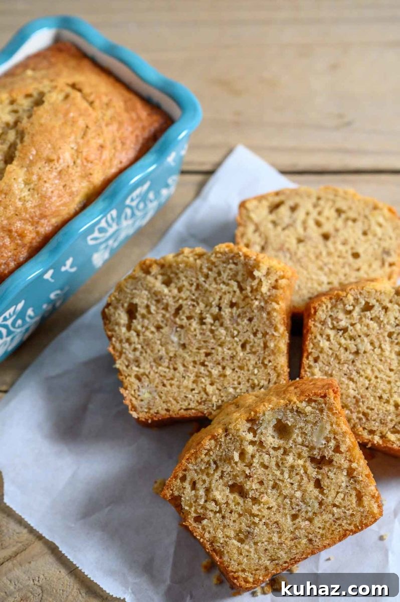 Maui Banana Bread Recipe with Coconut and Macadamia Nuts 2 Maui Banana Bread slices on parchment paper.
