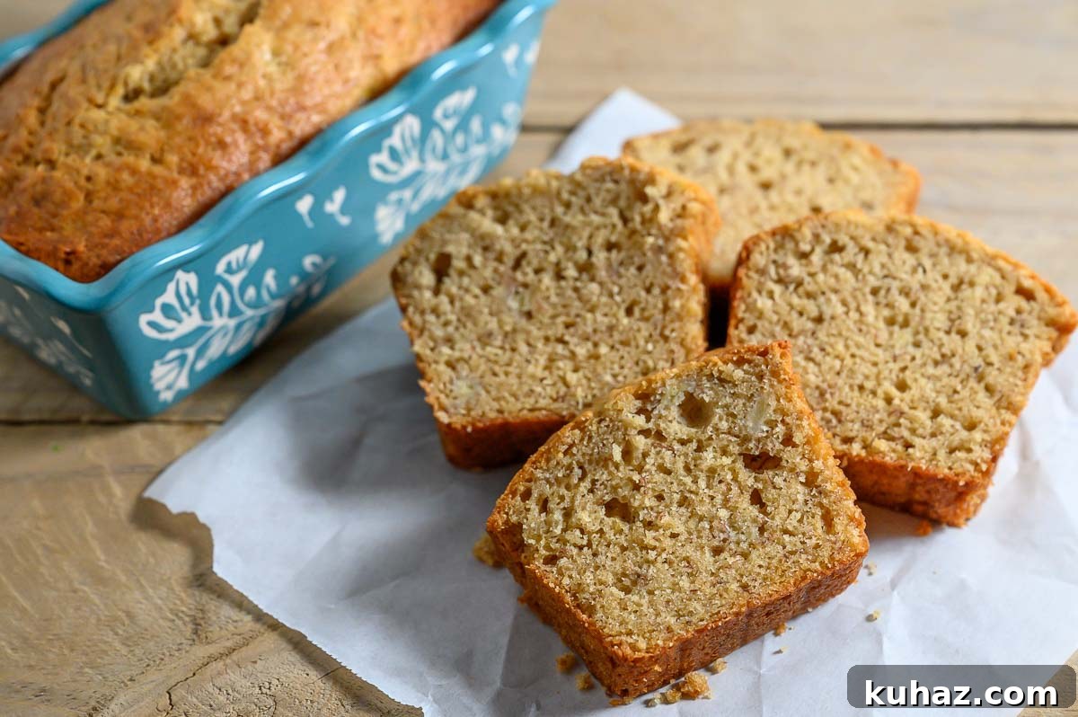 Maui Banana Bread Recipe with Coconut and Macadamia Nuts 6 Maui Banana Bread slices on parchment paper.