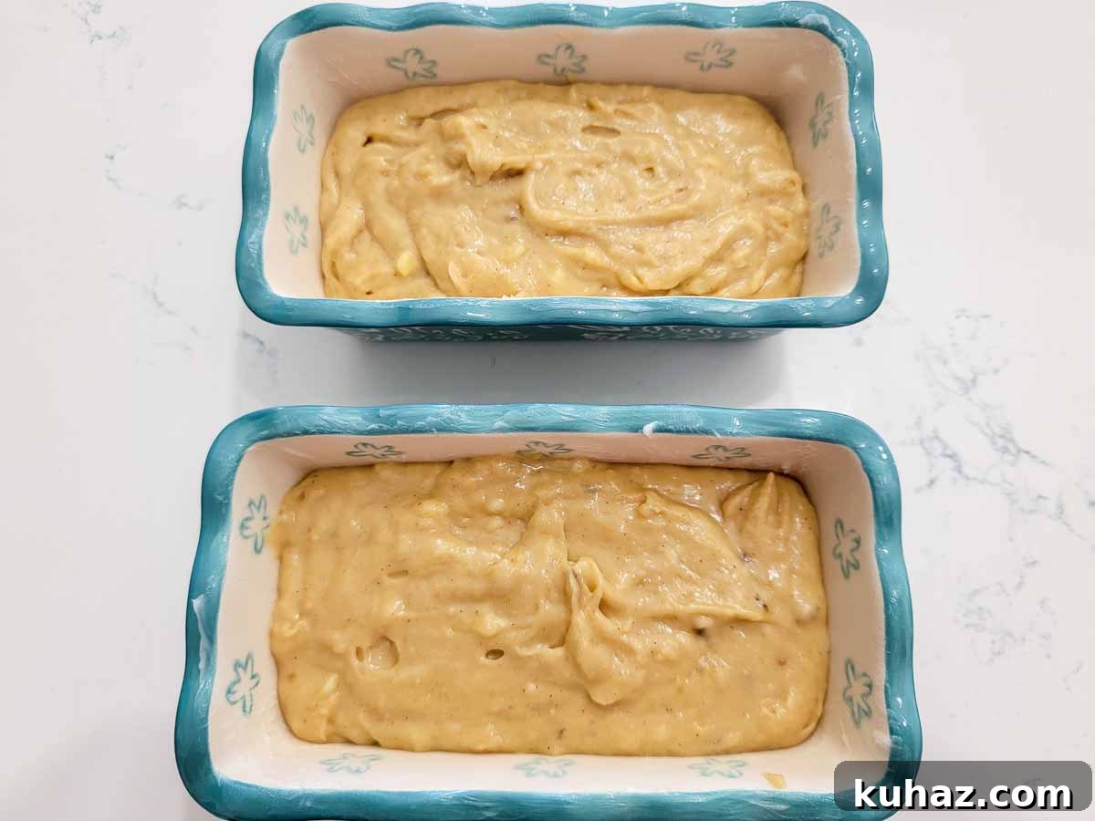 Maui Banana Bread Recipe with Coconut and Macadamia Nuts 5 banana bread batter in two mini loaf pans.