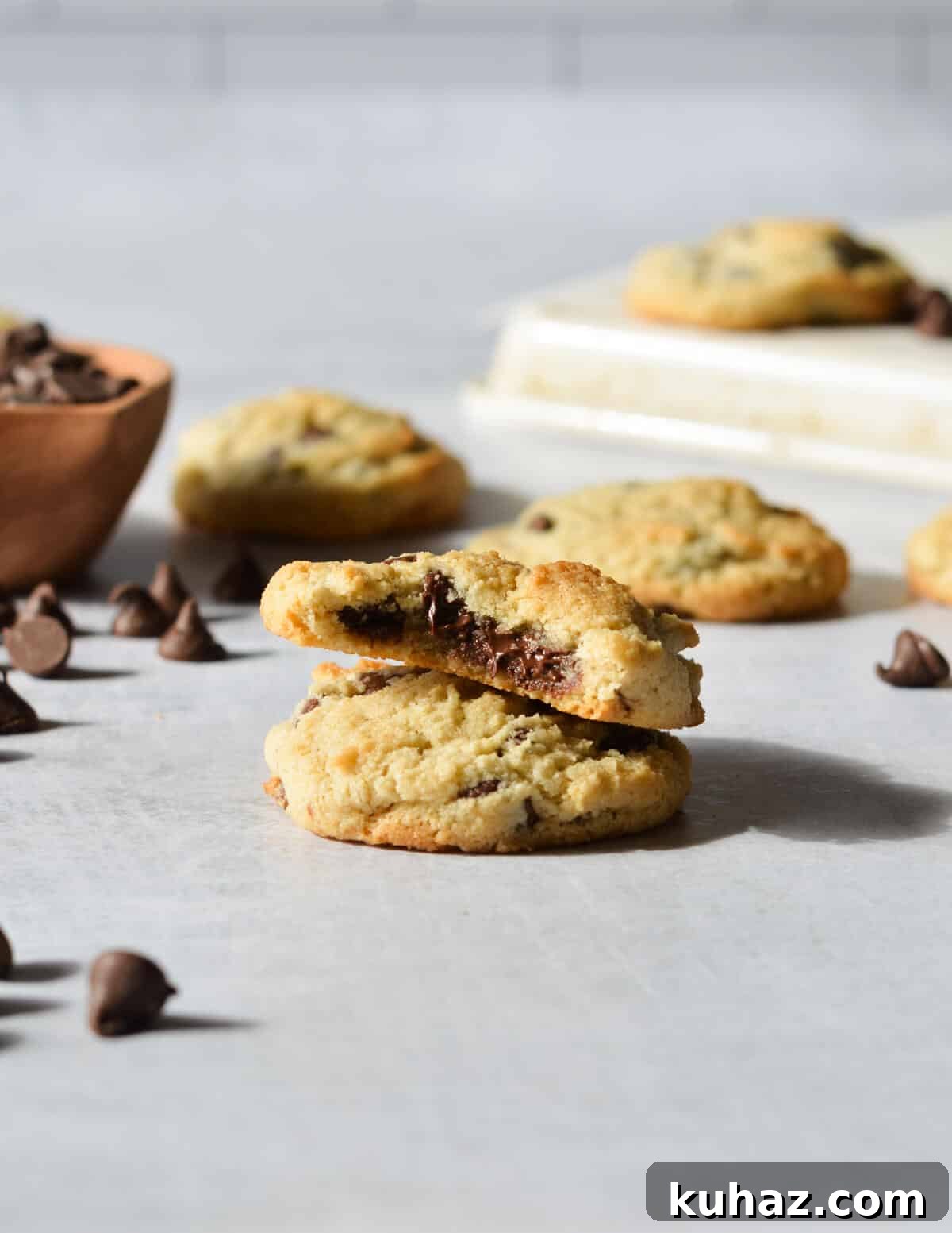 Soft and Chewy Almond Flour Chocolate Chip Cookie Recipe 11 a stack of two cookies, one with a bite out of it.