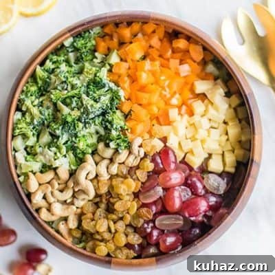 A healthy broccoli salad recipe with grapes, raisins, cashews, peppers, and cheese.