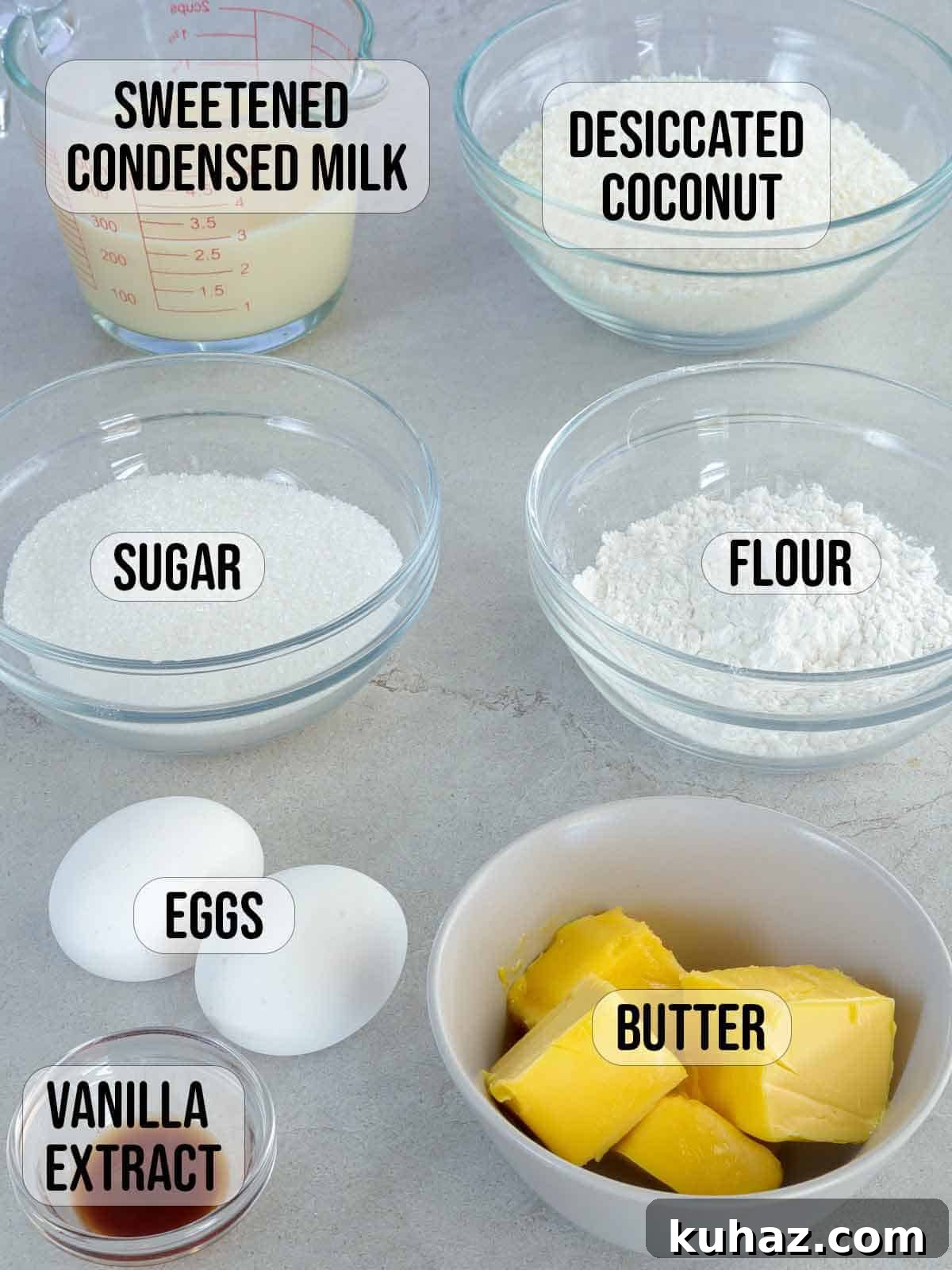 Filipino Coconut Macaroons with Condensed Milk 3 condensed milk, dessicated coconut, sugar, flour, eggs, butter, vanilla extract in bowls.