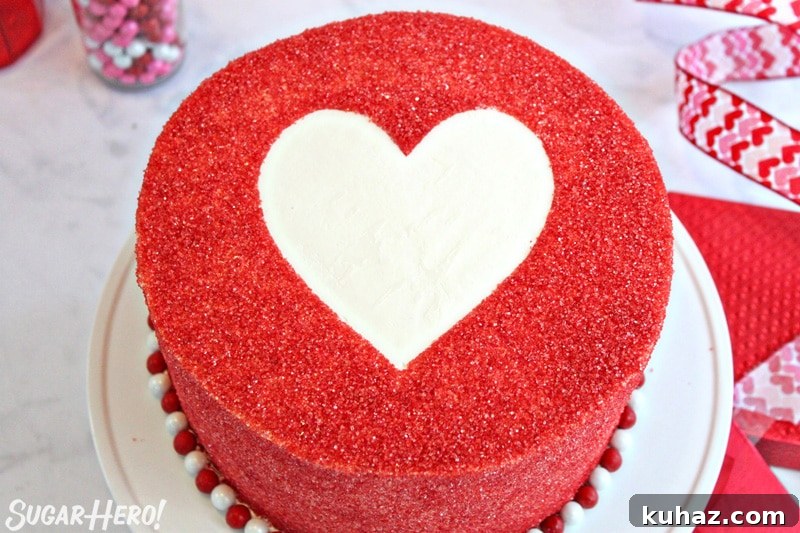 Cake covered with red sparkling sugar, with an empty white space in the center in the shape of a heart
