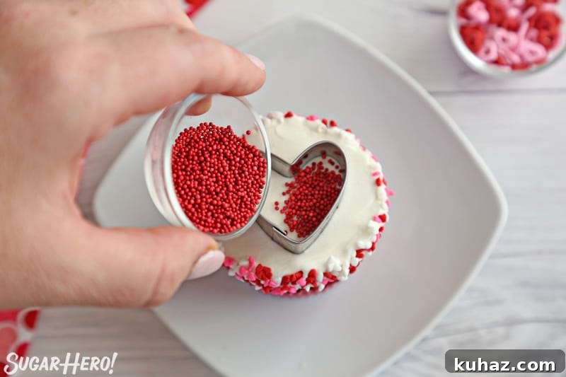 Filling the inside of a cookie cutter with small round sprinkles
