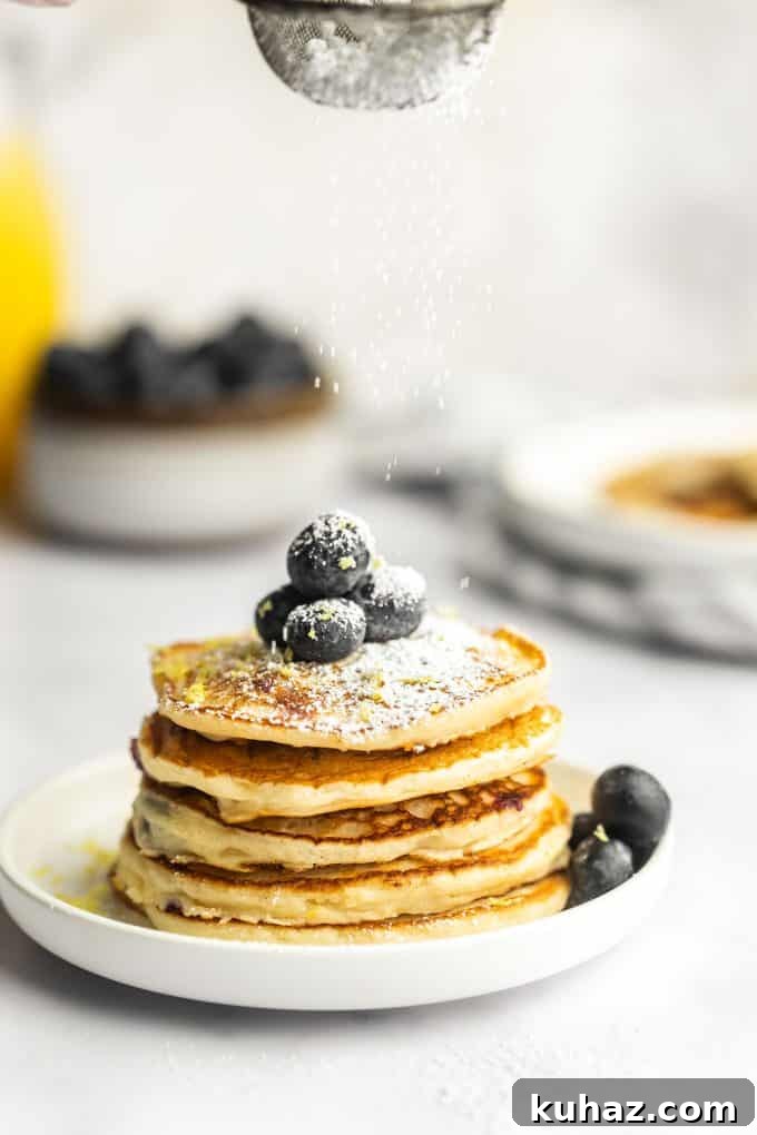 Fluffy Lemon Blueberry Pancakes with Maple Syrup 4 Cooking pancakes on a griddle