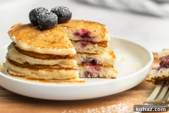Fluffy Lemon Blueberry Pancakes with Maple Syrup 5 Stack with lemon zest and blueberries