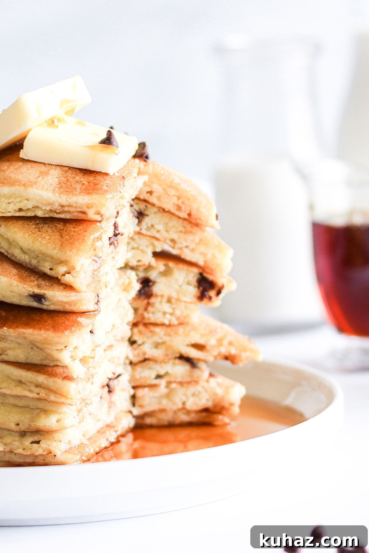 Gluten Free Buttermilk Pancakes Recipe 4 A tall stack of fluffy gluten-free pancakes served with butter and syrup.