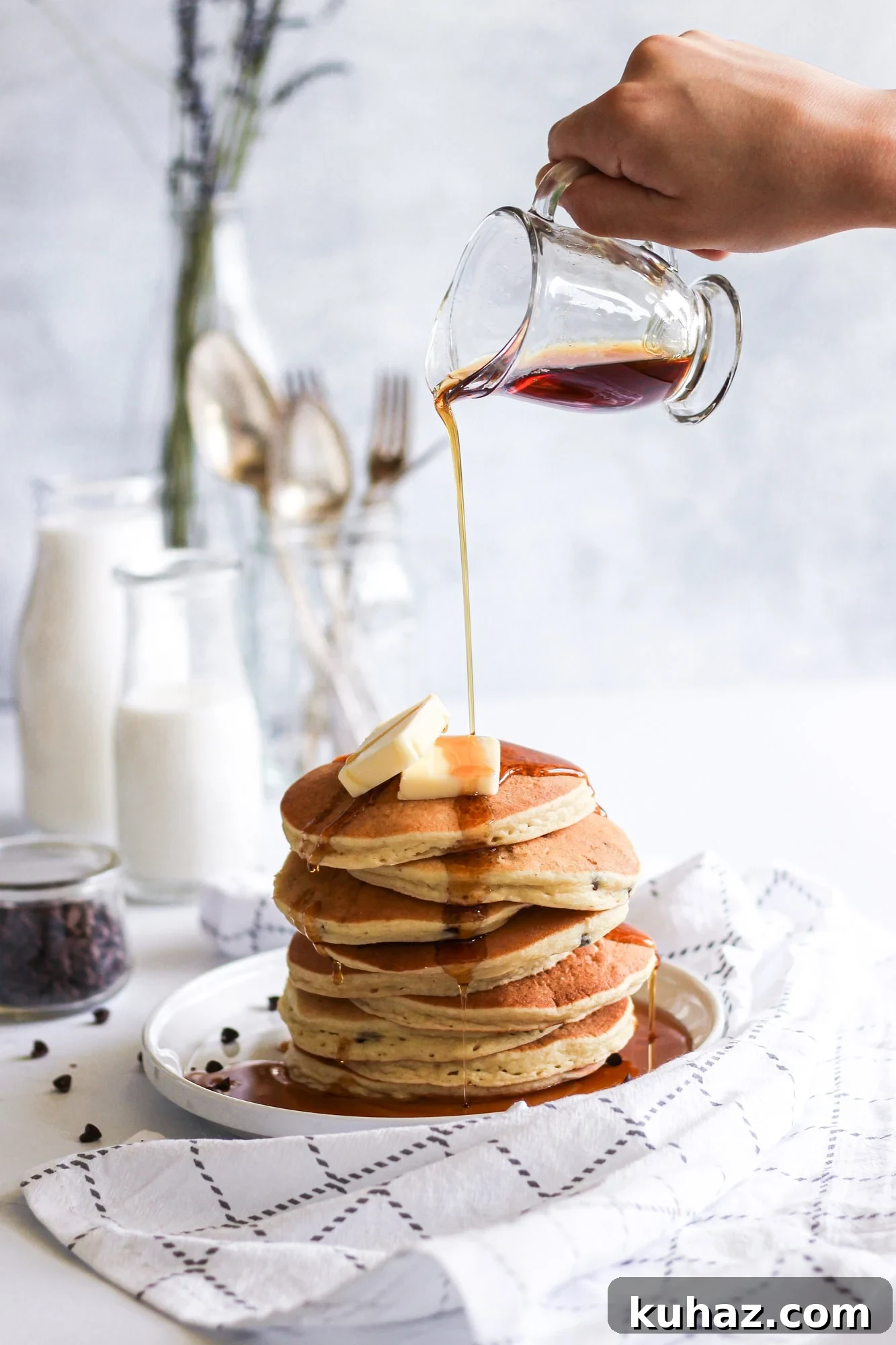 Gluten Free Buttermilk Pancakes Recipe 5 Maple syrup being poured over a stack of homemade gluten-free pancakes.