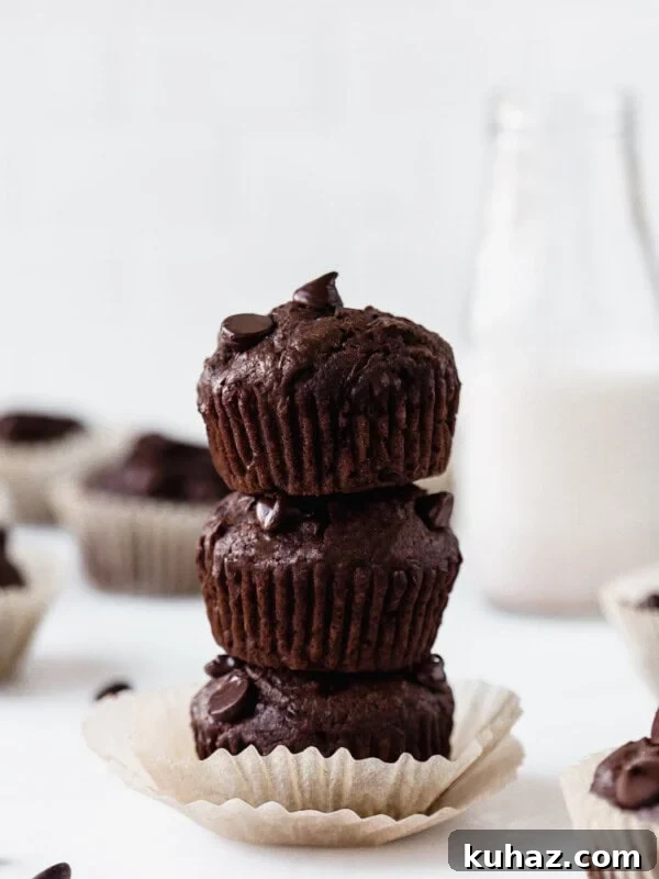 three chocolate zucchini muffins stacked