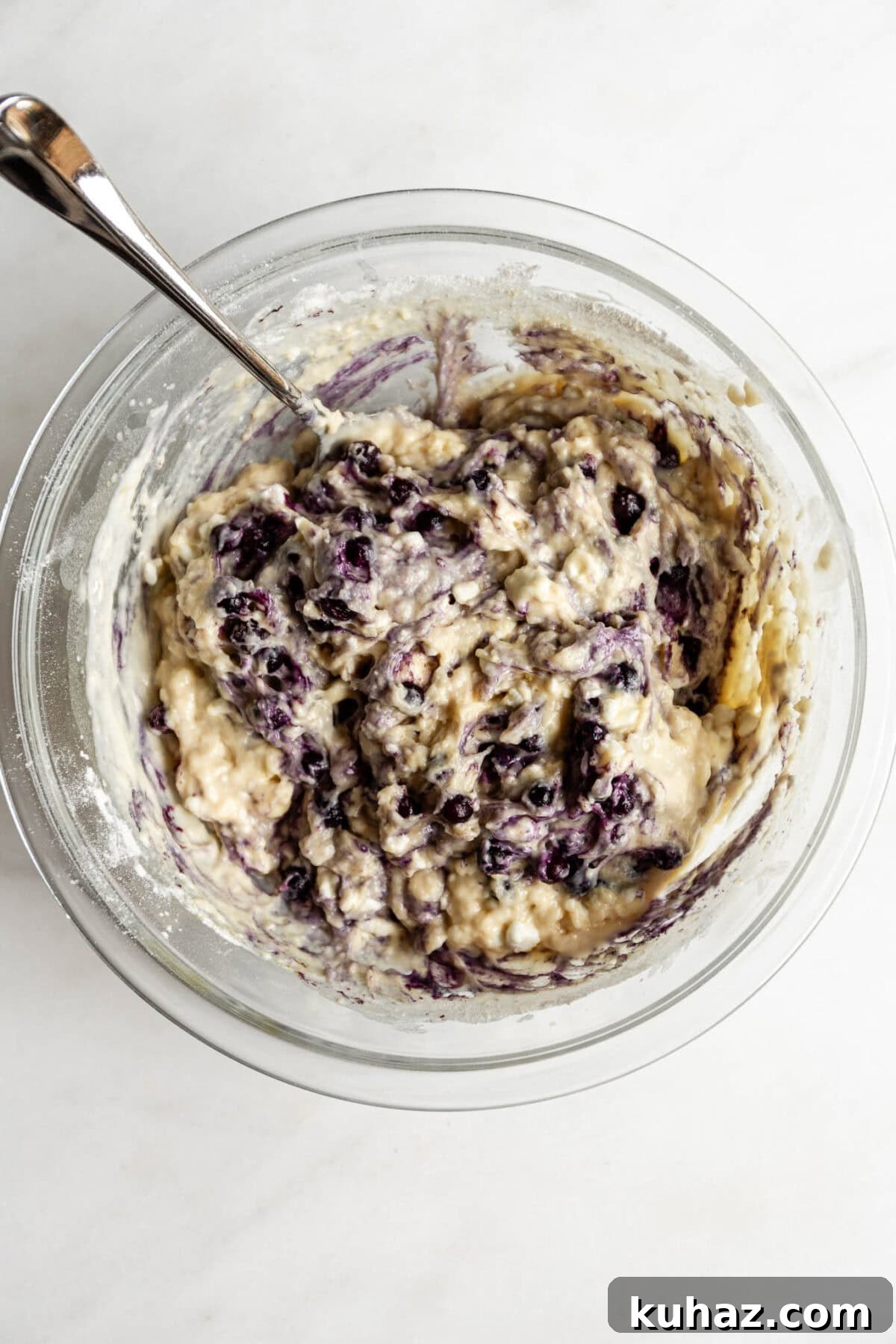 cottage cheese blueberry muffin batter in a mixing bowl.