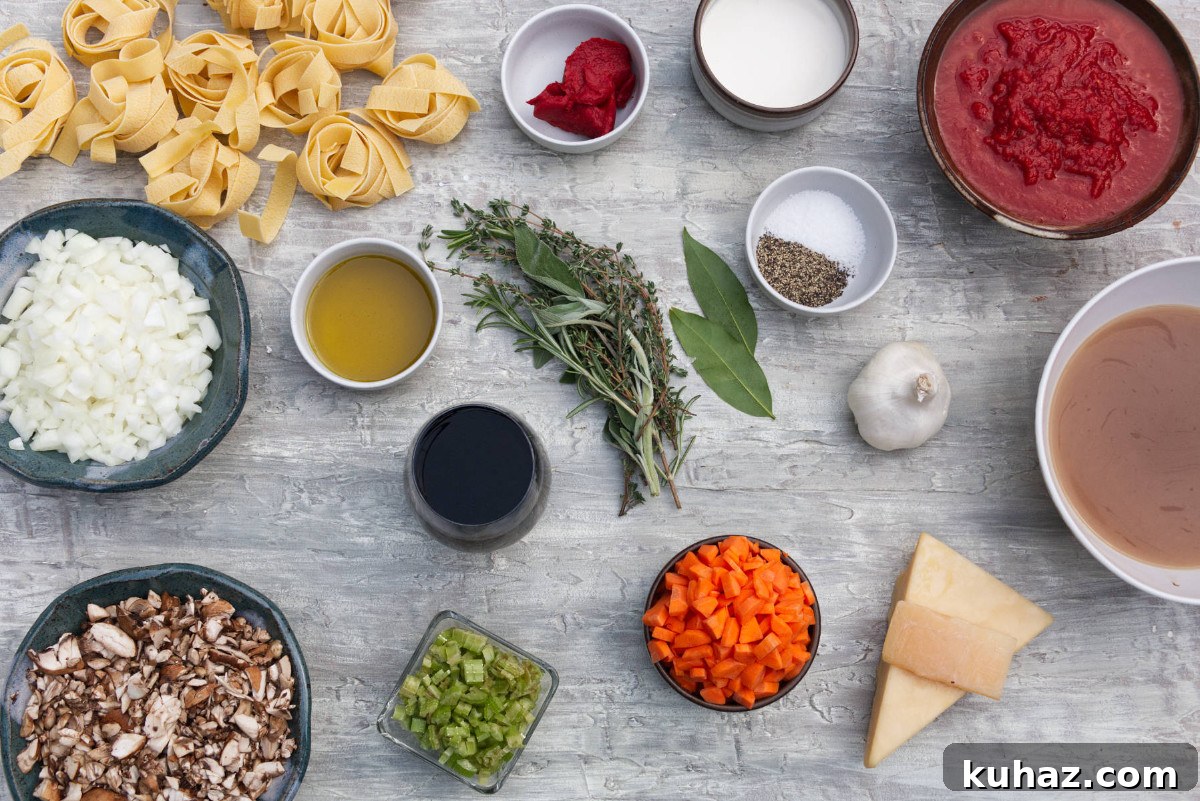 Traeger smoked short rib ragu ingredients: pappardelle pasta, tomato paste, cream, crushed tomatoes, salt, pepper, rosemary, sage, thyme, bay leaves, garlic, red wine, olive oil, onion, mushrooms, celery, carrots, parmesan wedge, beef broth.