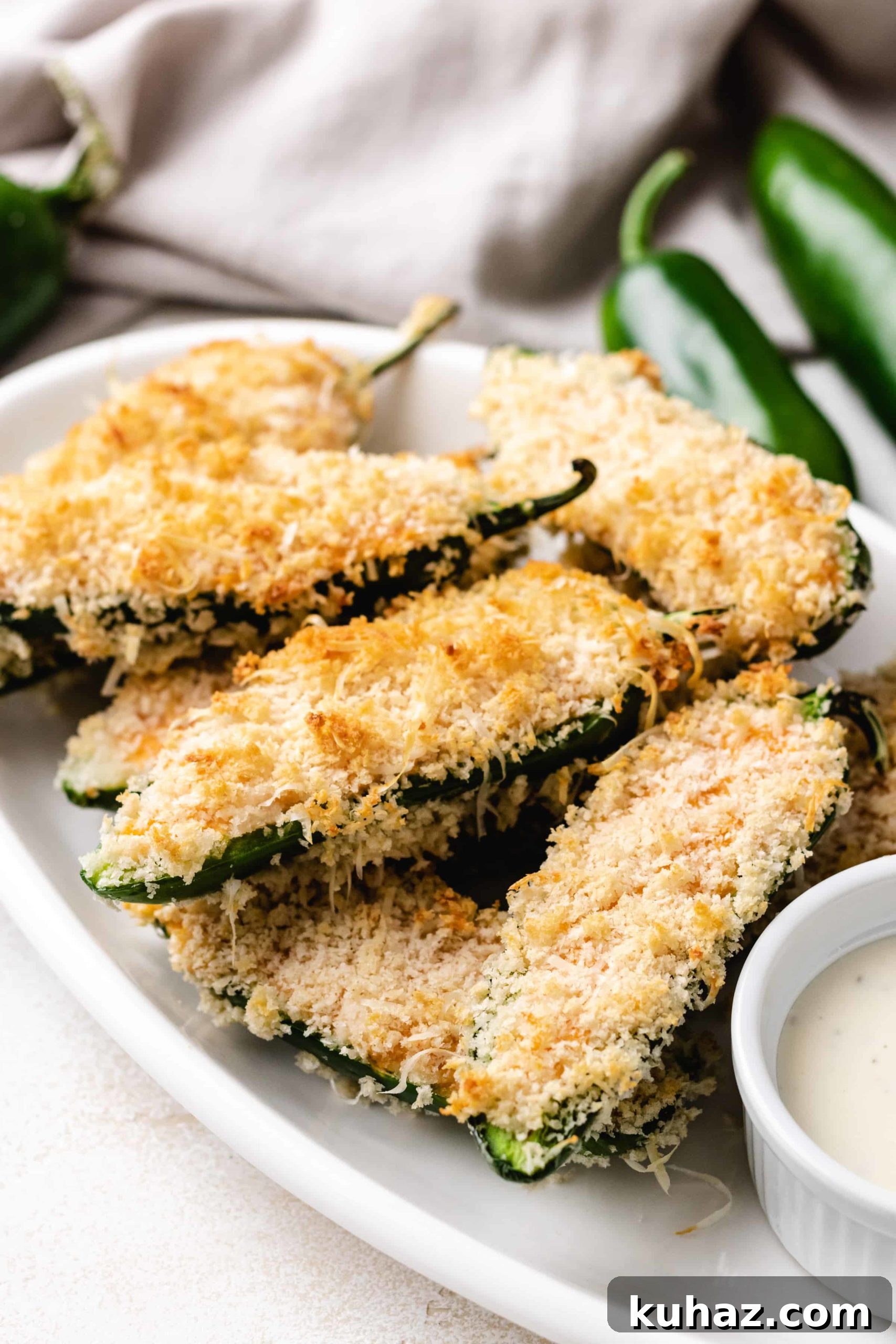 Crispy Oven-Baked Jalapeno Poppers with Cream Cheese 5 Side view of stuffed jalapeños on a plate.