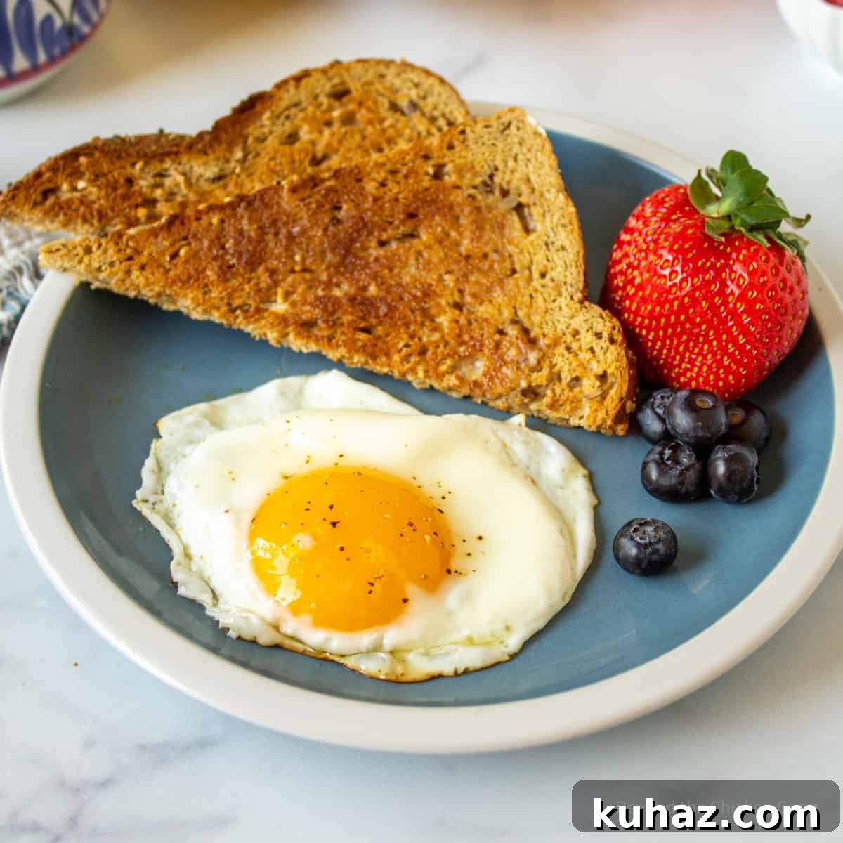 How to Make Perfect Sunny Side Up Eggs 2 A sunny side up egg on a plate.