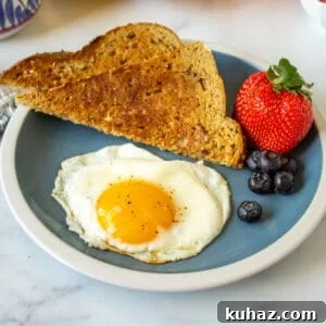 How to Make Perfect Sunny Side Up Eggs 11 A sunny side up egg on a plate.