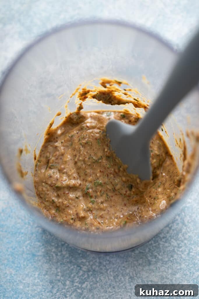 Container with an herb and mustard mixture (ingredient to make herb crusted lamb rack)
