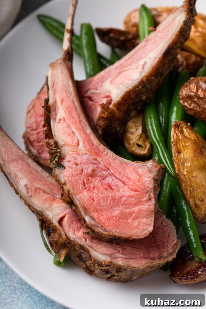 Medium rare lamb ribs on a white plate