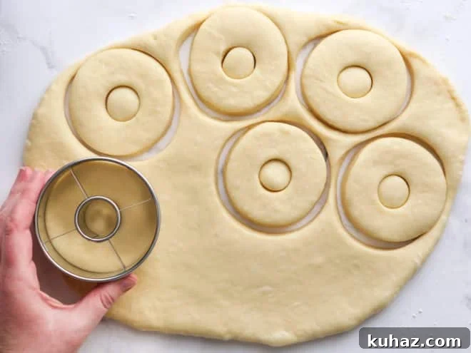 rolling out and cutting doughnuts