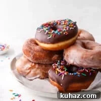 yeast-raised doughnuts stacked on a plate
