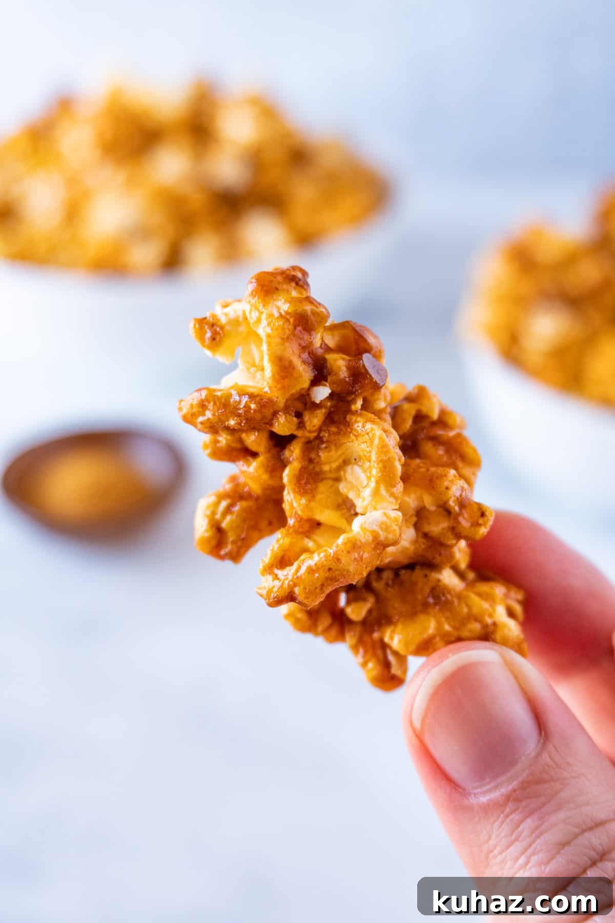 Spicy Buffalo Popcorn Recipe 3 holding a piece of buffalo popcorn