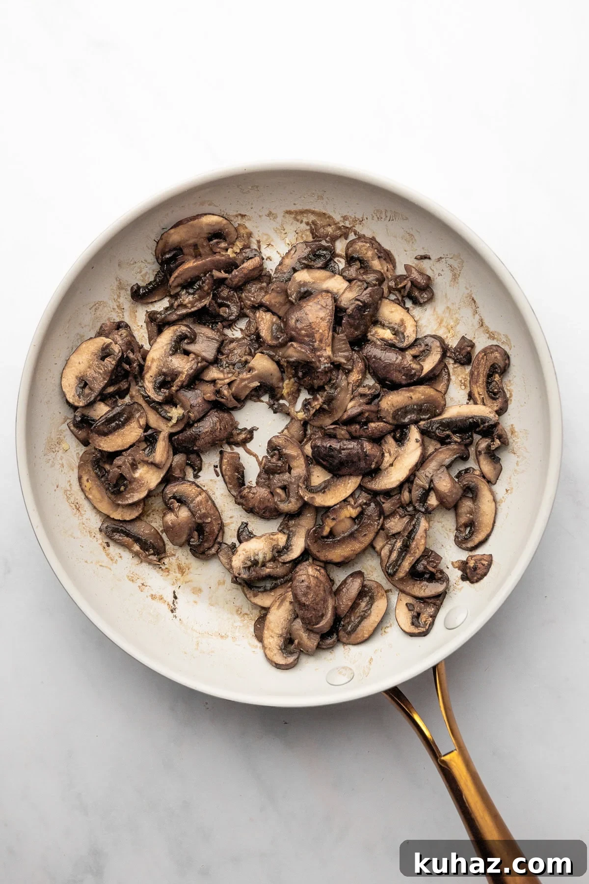 Creamy Mushroom Pasta with Garlic and Parmesan 5 An overhead image of sauteed mushrooms and garlic in a skillet.
