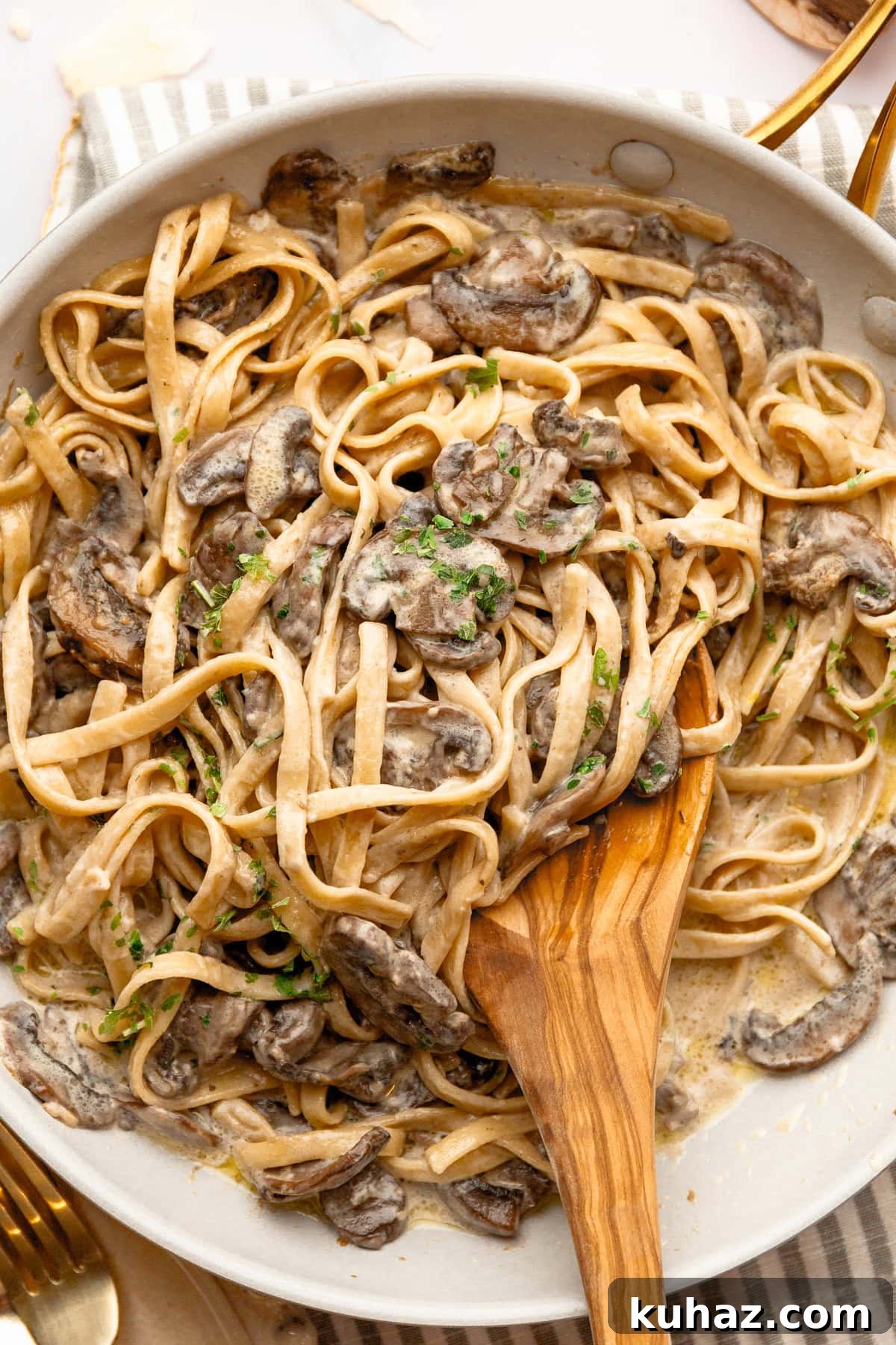 Creamy Mushroom Pasta with Garlic and Parmesan 8 A close up image of mixing mushroom fettuccine.