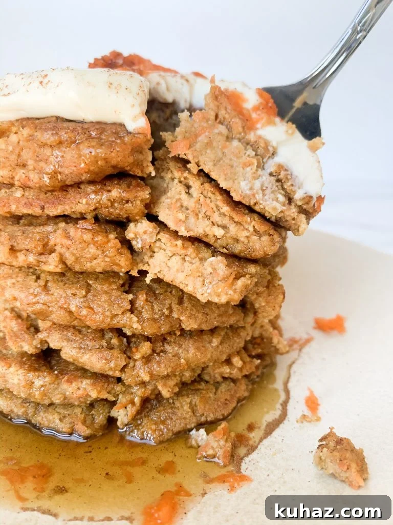 carrot cake pancakes with a fork taking a bite