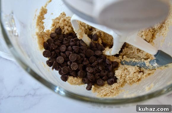 Edible Cookie Dough: Flourless, Eggless Recipe 4 A glass mixing bowl containing chocolate chips and cookie dough