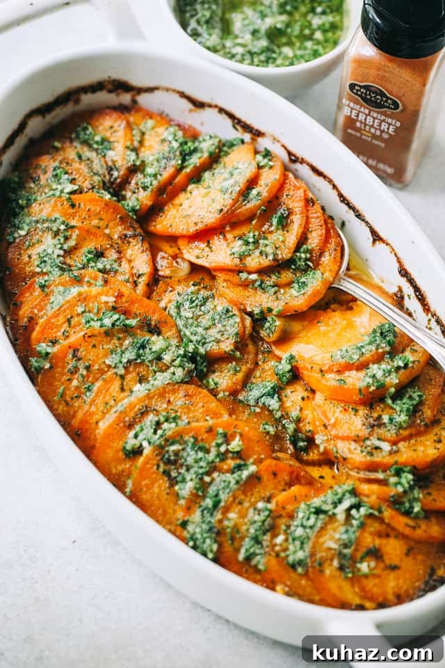 Sweet Potato Roast with Parsley Pesto in an oval casserole dish with a spoon