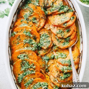 Sweet potatoes fanned out in a baking dish and topped with parsley pesto.