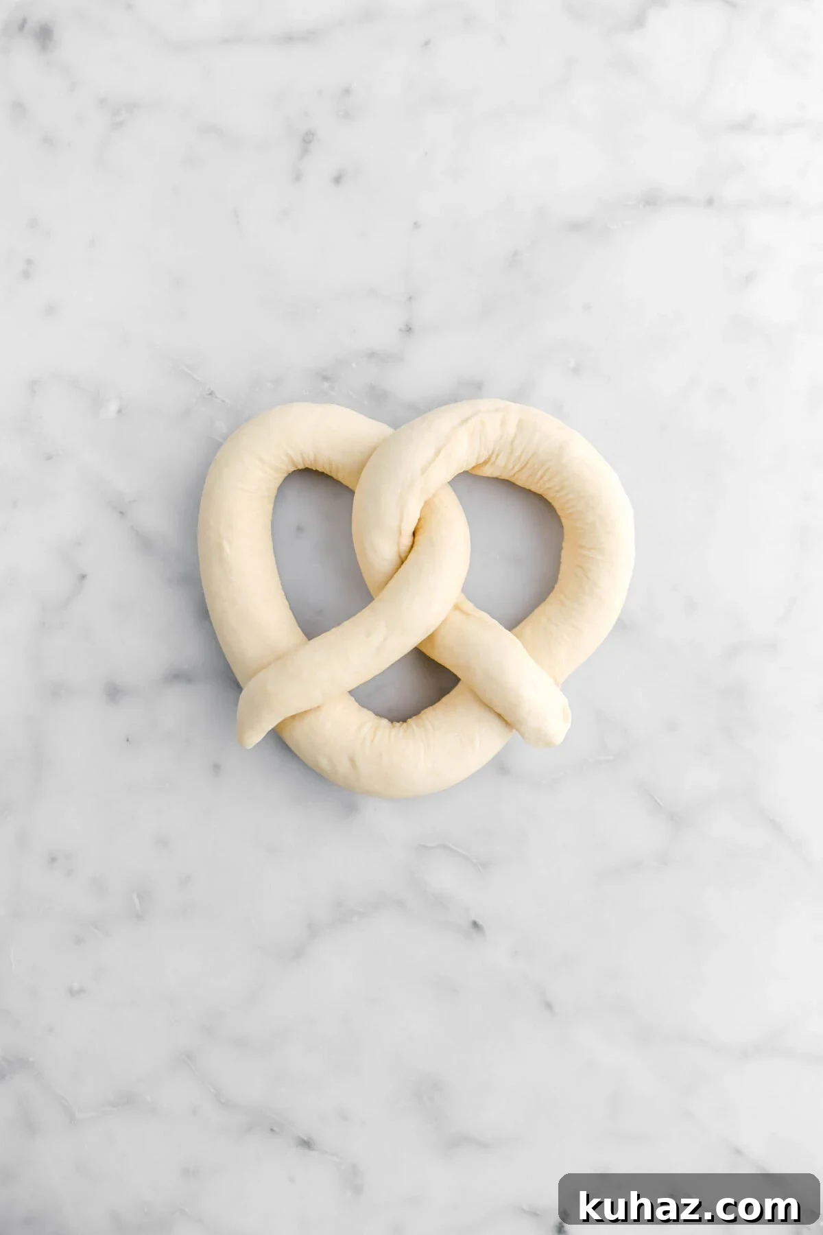 Giant Goat Cheese Stuffed Soft Pretzels 19 pretzel on marble surface.
