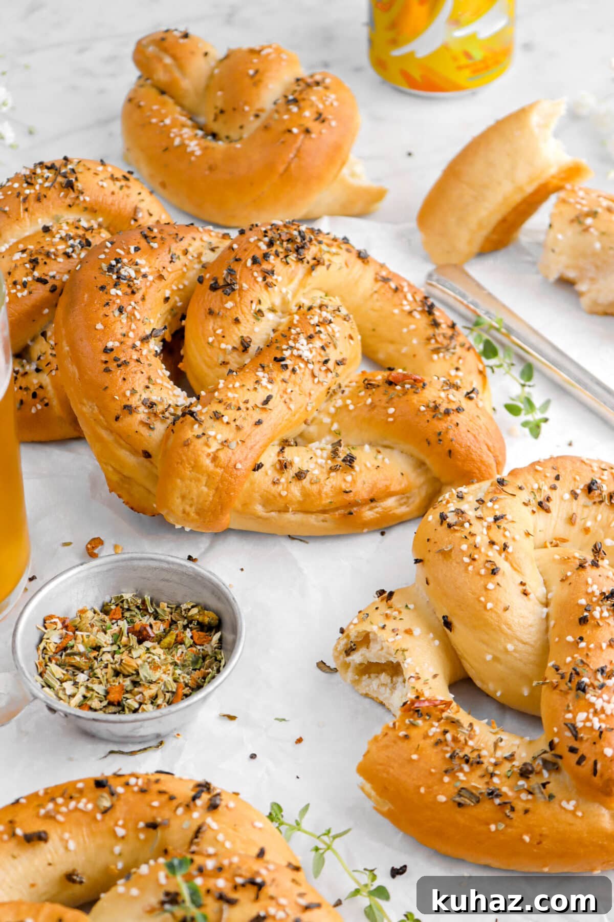 Giant Goat Cheese Stuffed Soft Pretzels 4 pretzels on parchment paper with a bite missing from one.