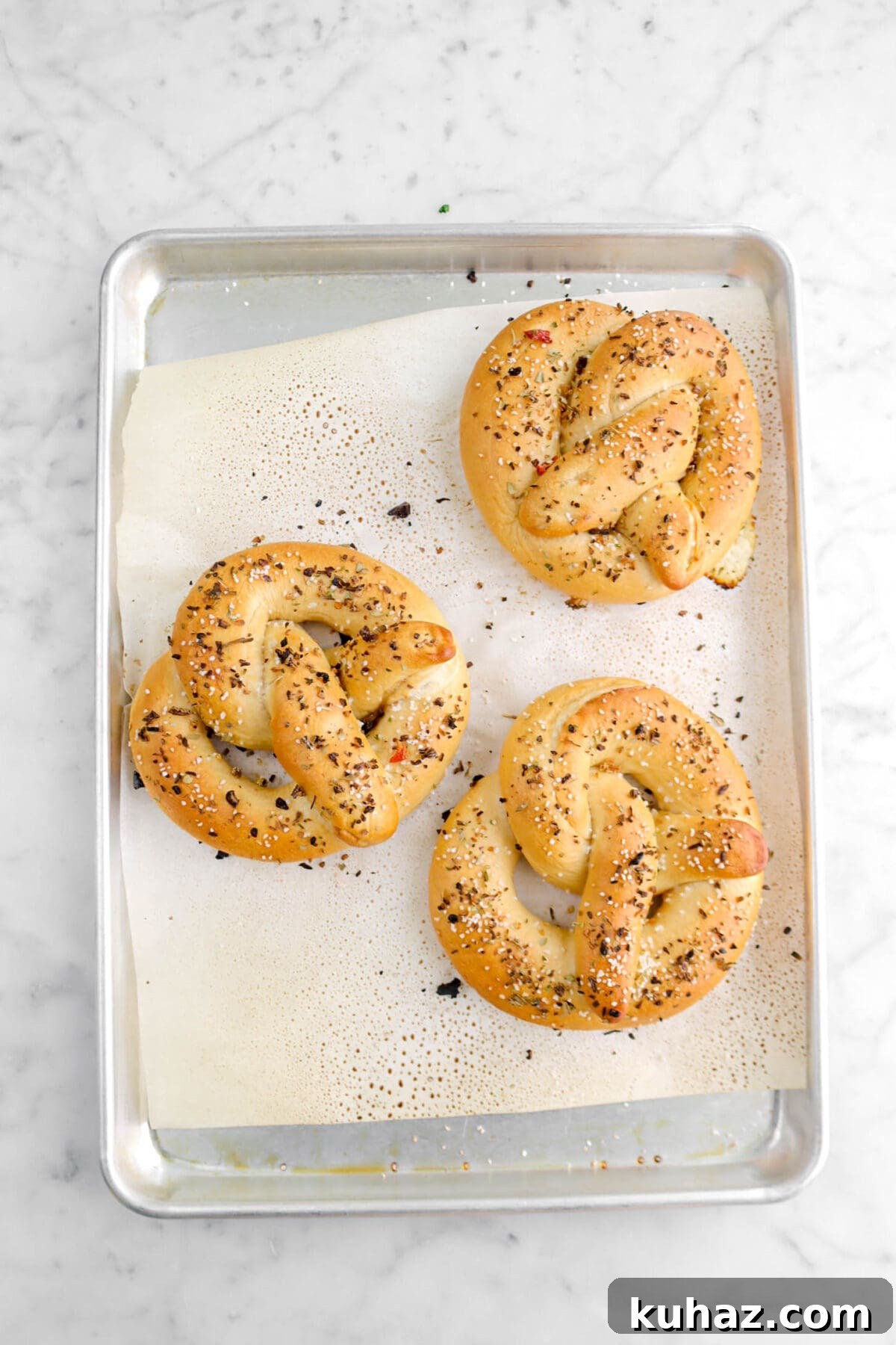 Giant Goat Cheese Stuffed Soft Pretzels 24 three baked pretzels on lined sheet pan.