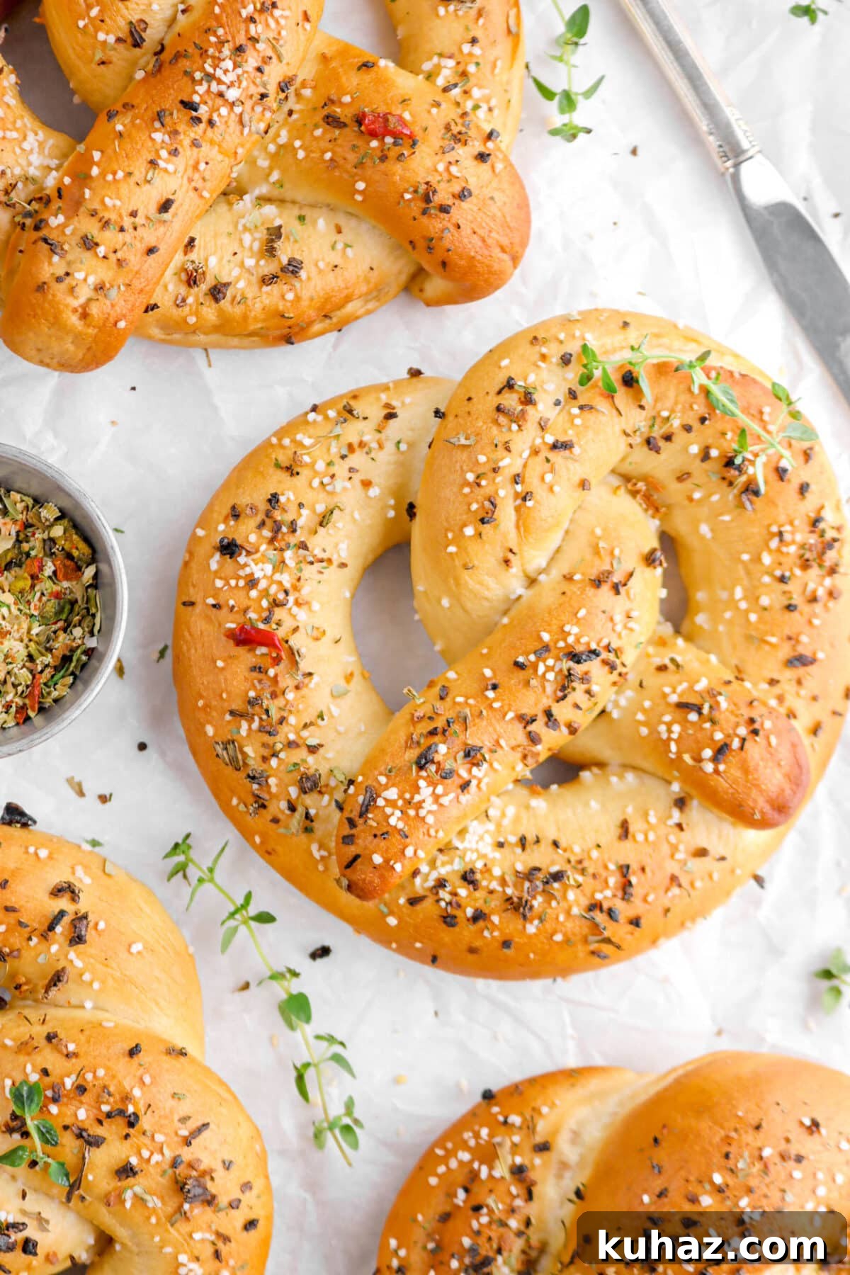 Giant Goat Cheese Stuffed Soft Pretzels 25 cropped close up of pretzel with thyme sprig on top.