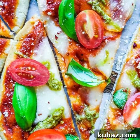 Overhead shot of sliced pizza on a cutting board.