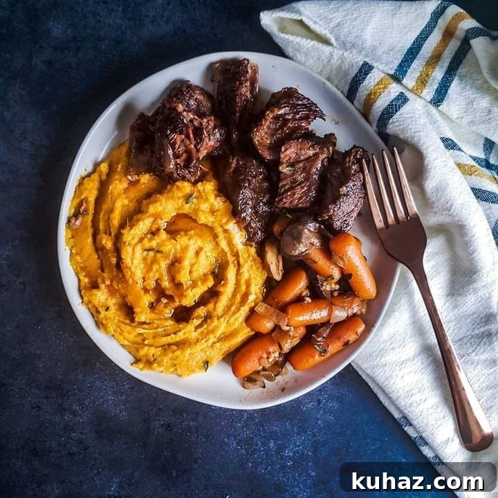 White plate with short ribs and sides on it.