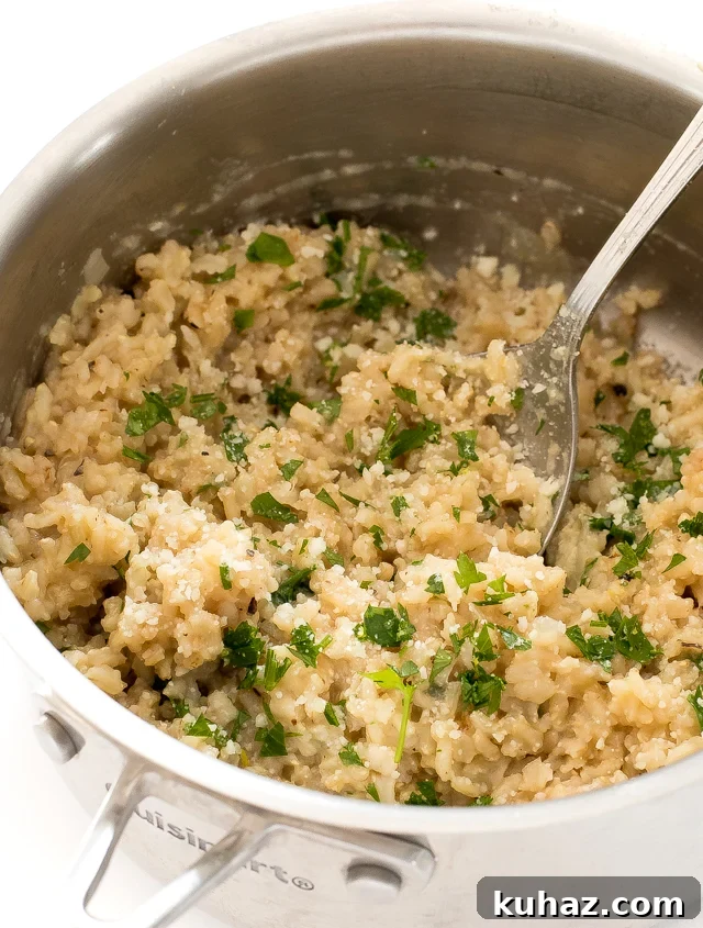 Zesty Lemon Parmesan Brown Rice Recipe 3 fluffing rice in silver saucepan