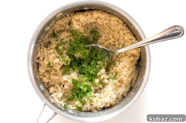 Zesty Lemon Parmesan Brown Rice Recipe 6 adding parsley to the cooked rice