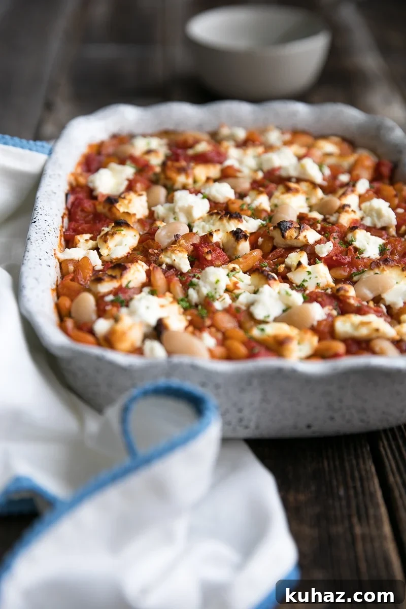 Vegetarian Baked Tomato Beans with Tangy Feta 4 Close up of tomato-baked beans topped with crumbled feta.