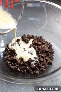Homemade Chocolate Hazelnut Rum Truffles Recipe 5 pouring cream onto chocolate pieces in bowl