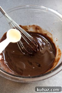 Homemade Chocolate Hazelnut Rum Truffles Recipe 7 pouring rum into melted chocolate mixture