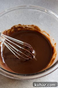 Homemade Chocolate Hazelnut Rum Truffles Recipe 8 melted rum truffle mixture in a bowl with a whisk